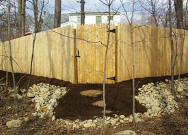 Stone wall with iron railing.